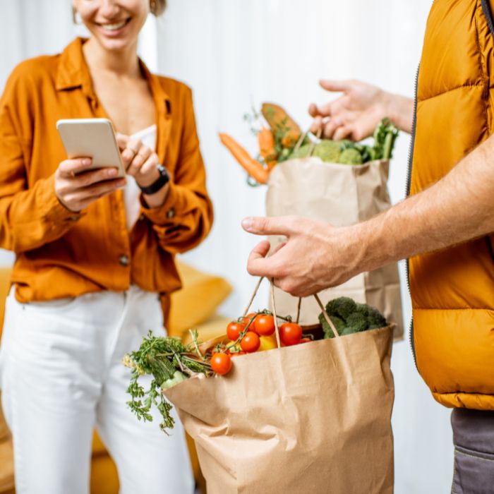 man with two bags of groceries