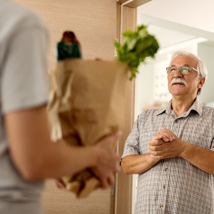 older man getting groceries delivered